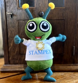 Stampy the stamp bug wearing his Patron badge